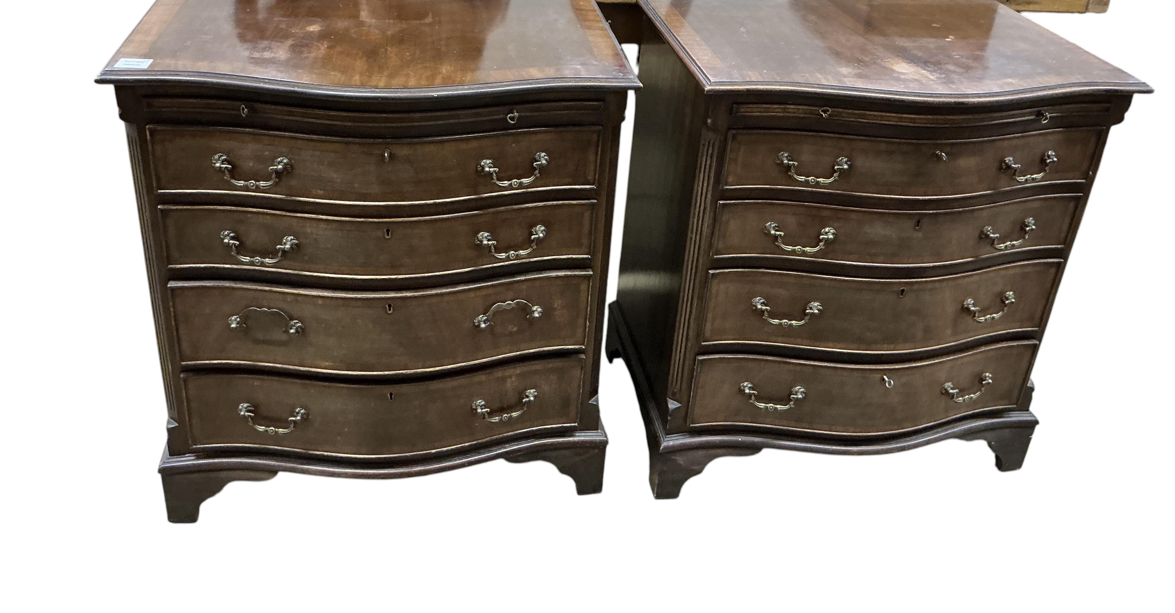 A pair of reproduction George III style serpentine mahogany four drawer chests with brushing slides, width 71cm, depth 49cm, height 77cm